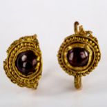 A pair of Roman unmarked gold cabochon garnet earrings, beaded and lobed circular medallions,