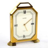 LUXOR - a Vintage brass-cased mantel clock, retailed by Garrard & Co Ltd, white enamel dial with