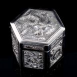 A small Chinese hexagonal silver box and cover, relief embossed phoenix and floral decoration,