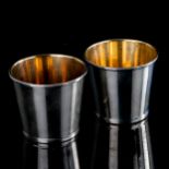 TIFFANY & CO - 2 modern Italian sterling silver beakers, plain tapered cylindrical form with gilt