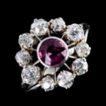 An Antique platinum "ruby" and diamond cluster target ring, set with old European-cut ruby and old-