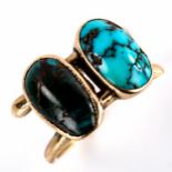 A Continental unmarked gold double-turquoise crossover ring, set with oval cabochon turquoise