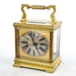 A large French brass-cased carriage clock, by L Vincent of Avignon, oval silvered dial with Roman