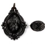 A large Victorian vulcanite floral pendant, and a small French jet bombe brooch, pendant height