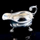 An Edwardian silver sauce boat, gadrooned rim with shell feet and scrolled C-shape acanthus leaf