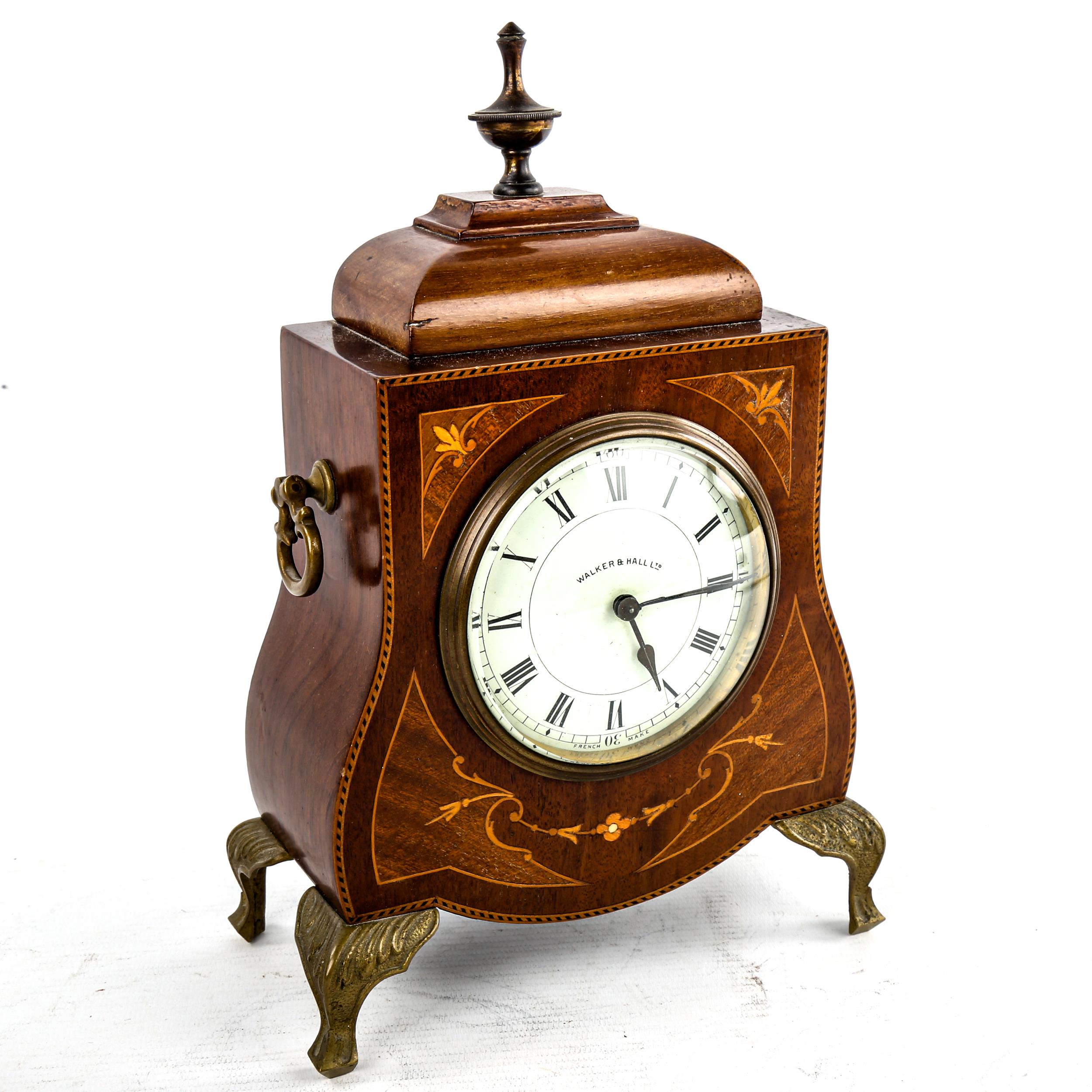 An Edwardian inlaid shaped mahogany mantel clock, by Walker & Hall Ltd, white enamel dial with Roman