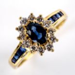 A modern 18ct gold sapphire and diamond cluster ring, set with oval mixed-cut sapphire, round