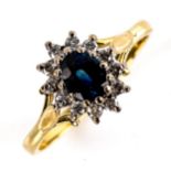 A late 20th century 18ct gold sapphire and diamond cluster ring, set with oval mixed-cut sapphire