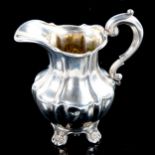 A Victorian silver pumpkin cream jug, scrolled foliate feet with gilt interior, indistinct maker's