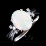 A late 20th century 14ct white gold dress ring, set with oval cabochon white opal and round