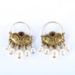 A pair of unmarked yellow metal Turkish crescent hoop earrings, set with cabochon garnets and en