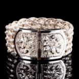 A large modern silver basketweave bracelet, with relief embossed floral buckle, bracelet width 30.