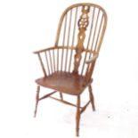 A Windsor wheel-back armchair, with elm seat, on turned legs