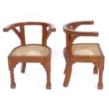 A pair of Indian Colonial design hardwood bow-arm chairs, with cane panel seats and spiral turned