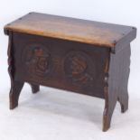 A small 1920s oak coffer, with figural carved roundels, W67cm, H50cm, D31cm