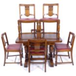 A 1930s oak draw leaf dining table, together with a set of 6 matching dining chairs with carved