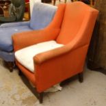 An Edwardian upholstered wing armchair