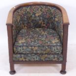 An oak-framed Arts and Crafts style tub chair, with William Morris style upholstery