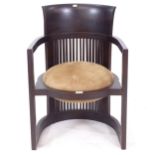 A Frank Lloyd Wright style barrel chair with suede leather seat