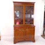 A mahogany 2-section library bookcase, having 2 astragal glazed doors, drawers and cupboards to