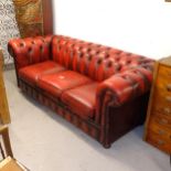 A red studded leather-upholstered rollover-arm Chesterfield settee, L200cm, H76cm, seat height