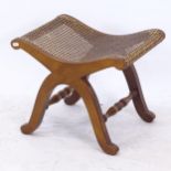 A walnut X-framed cane-seated stool, W48cm, H38cm