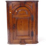 An Antique pine hanging corner cupboard, W71cm, H95cm