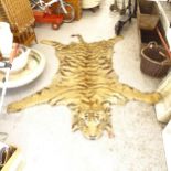 TAXIDERMY - an early 20th century tiger-skin rug, with hessian backing, L280cm, back leg width 220cm