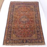 A red ground Persian design rug, with symmetrical border, 206cm x 137cm