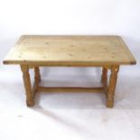 A rectangular oak kitchen table, raised on baluster turned legs with H-shaped stretcher, W152cm,