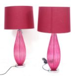 A pair of contemporary cranberry glass table lamps, height including shade 70cm