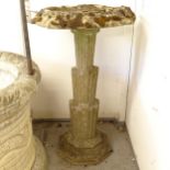 A weathered concrete birdbath, on an Art Deco style column support with plinth base, W65cm, H107cm