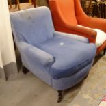 An early 20th century Howard style upholstered armchair, with loose cushion, on turned legs