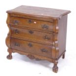 A small oak 3-drawer bombe chest, on claw and ball feet, W78cm, H68cm, D40cm
