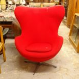 A contemporary design red upholstered swivel egg chair