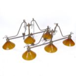 A pair of Vintage brass snooker table light fittings, each having 3 orange glass shades, shade