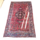 A red ground Bokora rug, with symmetrical border and lozenge, 210cm x 126cm