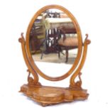 A reproduction mahogany swing toilet mirror, W64cm, H80cm