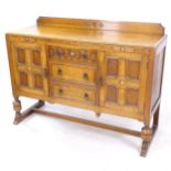 A 1930s carved oak sideboard, W140cm, H103cm, D51cm