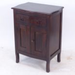 A hardwood cabinet of serpentine form, with single drawer, and panelled cupboards under, W61cm,