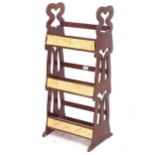An Arts and Crafts mahogany bookstand, with pierced stylised sides, W37cm, H86cm
