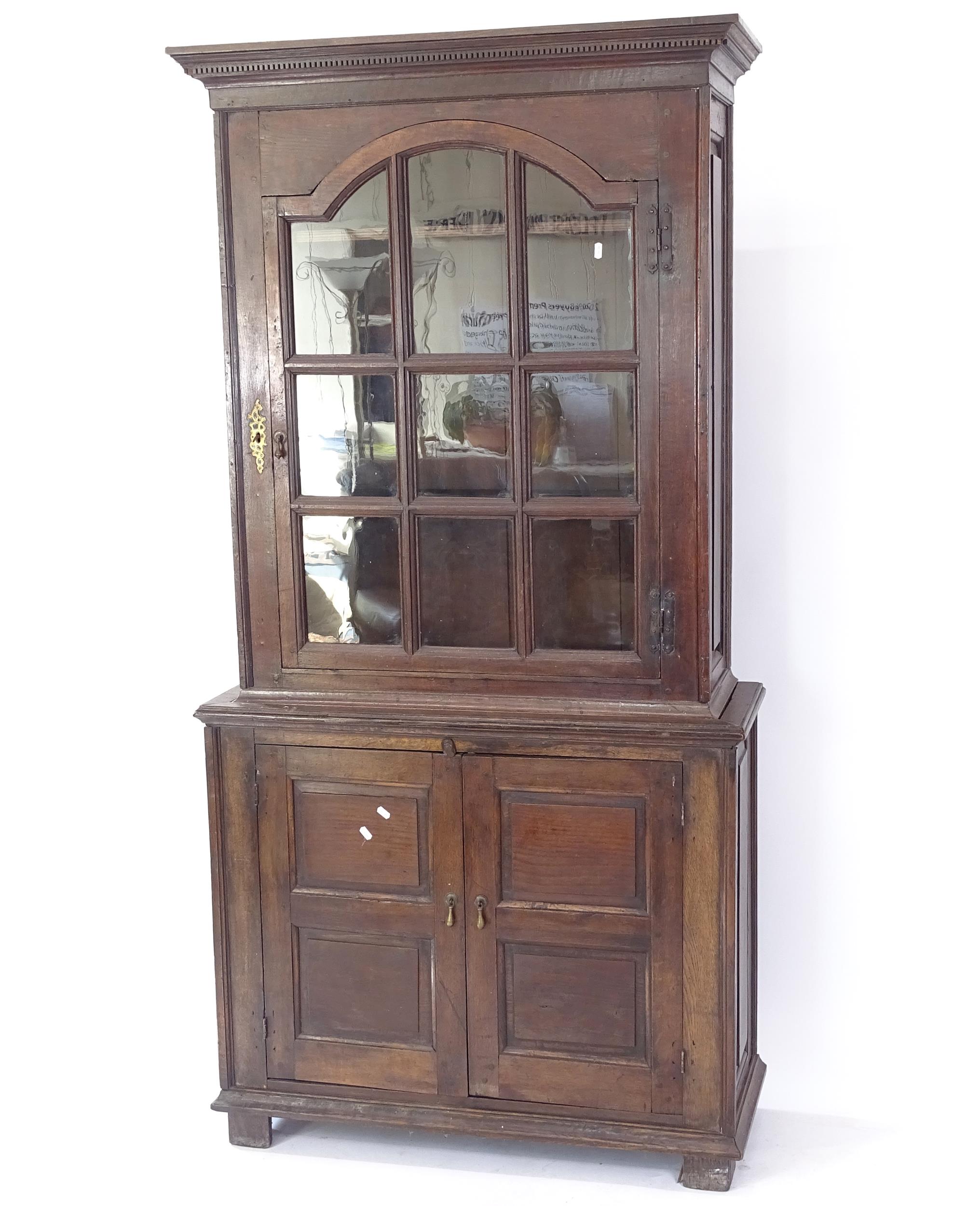 An Antique oak 2-section bookcase, with cupboards under, W100cm, H200cm, D42cm