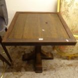An oak and iron-framed square pub table