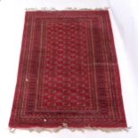 A red ground Tekki design rug, 180cm x 130cm