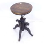 A revolving stool on a carved sabre leg base