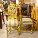 A pair of ornate gilt side chairs, with pierced backs, on turned legs