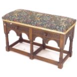 A 1920s oak duet stool, with 2 frieze drawers, allover carved decoration, with William Morris