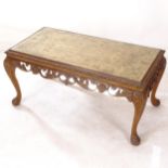 A 1930s walnut rectangular coffee table, with carved and pierced decoration, on cabriole legs,