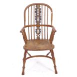 A yew wood and elm-seated bow-arm Windsor chair, with crinoline stretcher
