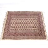 A cream ground Afghan design rug, 145cm x 124cm